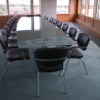 Glass Conference Table with Black Leather Chairs