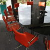 Oval Meeting Table in Black Glass with Red Chairs