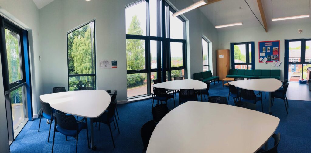 Classroom meeting tables arranged at St Faith & St Martin Church of England Junior School